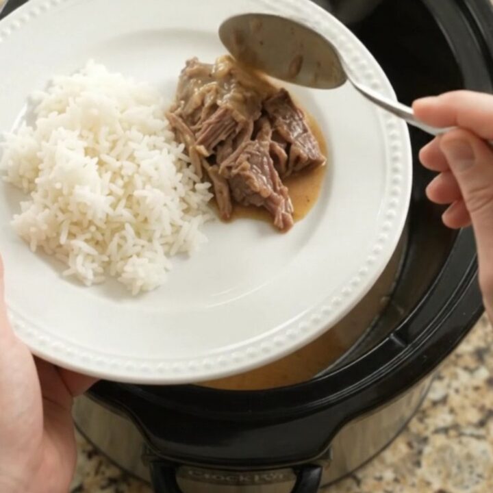 Shredded beef pot roast with potatoes and carrots in creamy Dijon gravy in a slow cooker