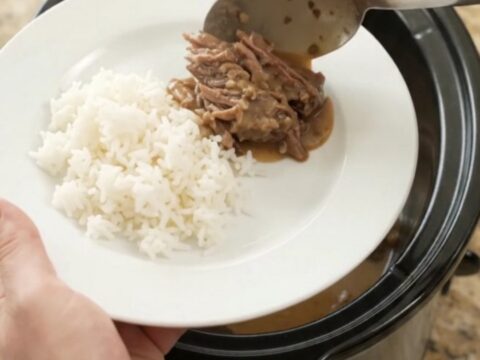 Slow cooker beef roast with portobello mushrooms and creamy Dijon sauce, ready to serve