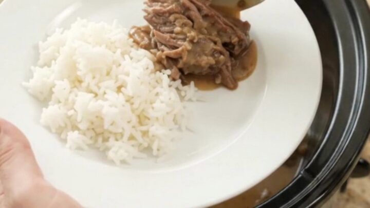 Slow cooker beef roast with portobello mushrooms and creamy Dijon sauce, ready to serve