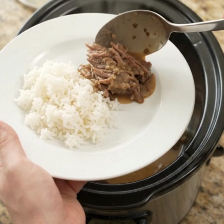 Slow cooker beef roast with portobello mushrooms and creamy Dijon sauce, ready to serve