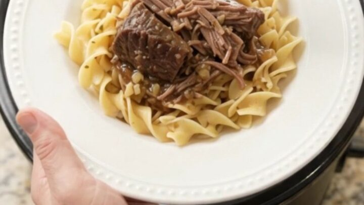 Slow cooker bottom round roast with peppers and butter, ready to serve