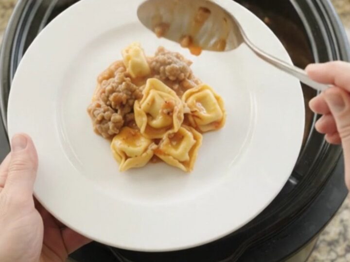 Bubbling Crockpot tortellini with sausage and melted provolone