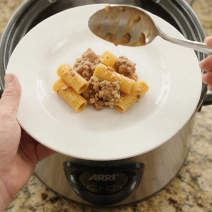 Bubbling crockpot rigatoni with sausage, ricotta, and melted provolone