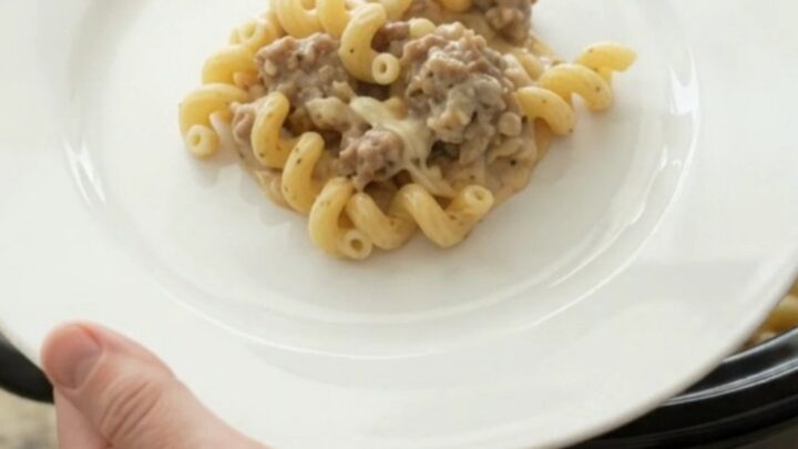 Creamy cavatappi pasta with sausage and melted mozzarella in a slow cooker