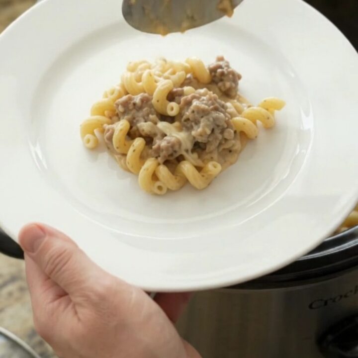 Creamy cavatappi pasta with sausage and melted mozzarella in a slow cooker