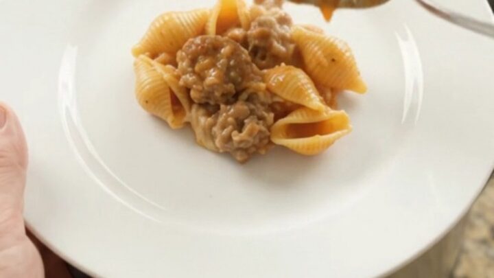 Crockpot Parmesan Sausage Red Pepper Shells bubbling in the slow cooker with melted cheese
