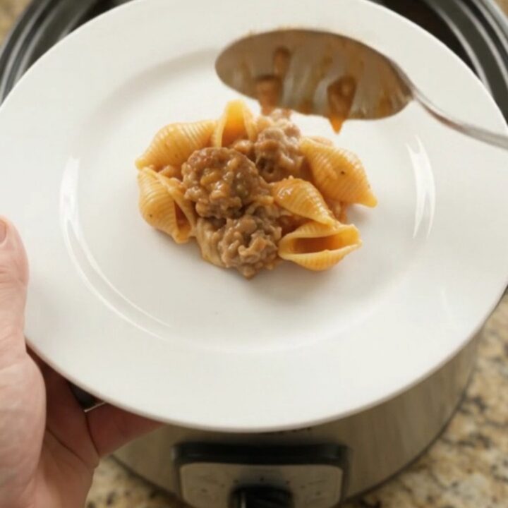 Crockpot Parmesan Sausage Red Pepper Shells bubbling in the slow cooker with melted cheese