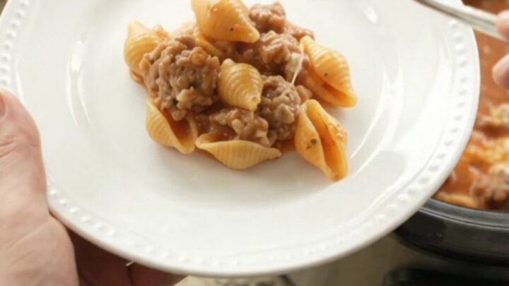 Bubbling Crockpot pasta with sausage, red pepper sauce, and melted provolone