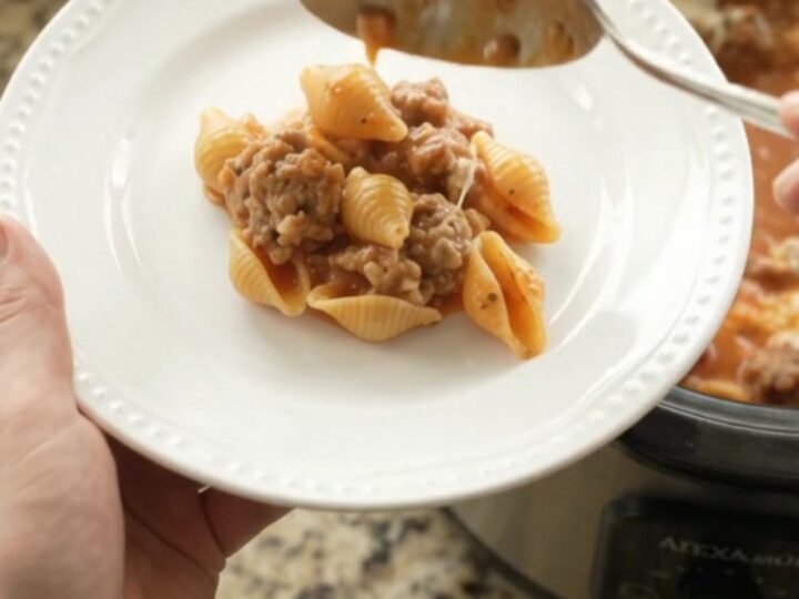 Bubbling Crockpot pasta with sausage, red pepper sauce, and melted provolone