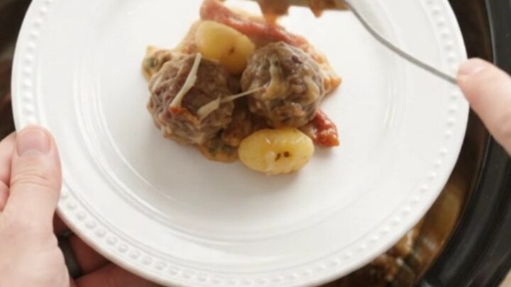 Bubbling Crockpot Parmesan Meatball Tuscan Gnocchi with melted cheese and steam