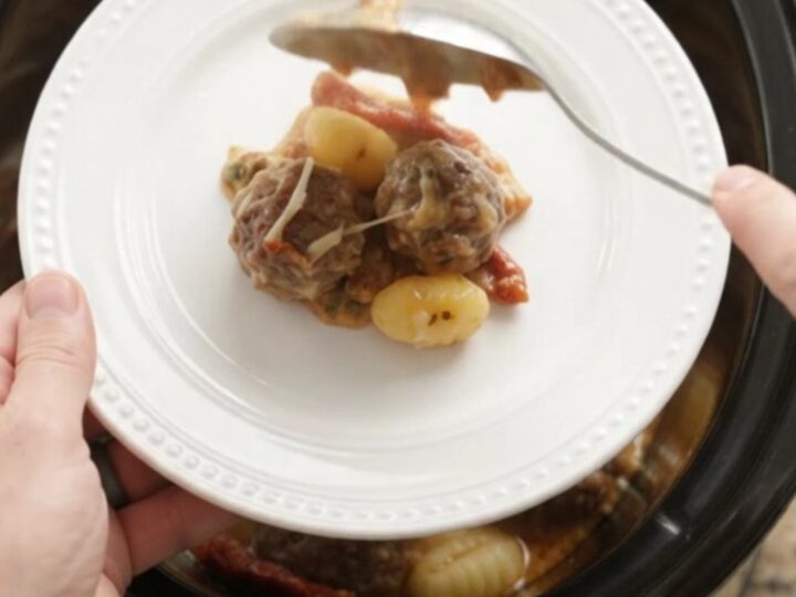 Bubbling Crockpot Parmesan Meatball Tuscan Gnocchi with melted cheese and steam