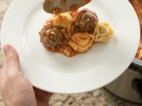 Bubbling Crockpot of Parmesan Meatball Marinara Tortellini with golden cheese crust
