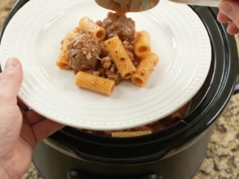 Crockpot Mozzarella Meatball Rigatoni in a slow cooker, with melted cheese and sauce