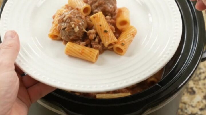 Crockpot Mozzarella Meatball Rigatoni in a slow cooker, with melted cheese and sauce