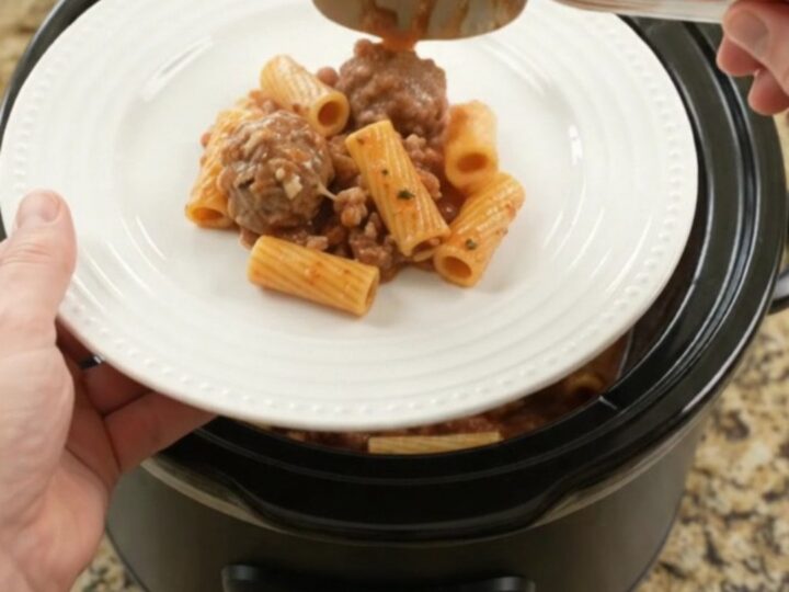 Crockpot Mozzarella Meatball Rigatoni in a slow cooker, with melted cheese and sauce