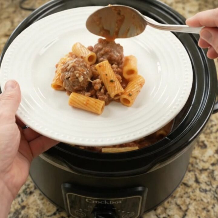 Crockpot Mozzarella Meatball Rigatoni in a slow cooker, with melted cheese and sauce