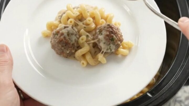 Creamy Crockpot meatball cavatappi with melted cheese and meatballs in a slow cooker