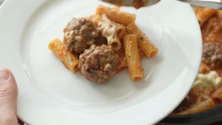 Bubbling Provolone Meatball Baked Ziti in a slow cooker with melted cheese.