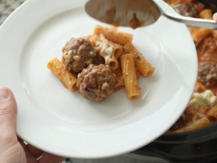 Bubbling Provolone Meatball Baked Ziti in a slow cooker with melted cheese.
