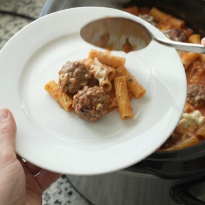 Bubbling Provolone Meatball Baked Ziti in a slow cooker with melted cheese.