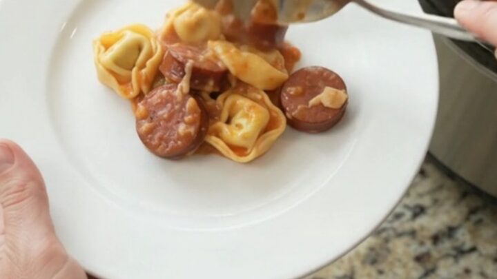 Slow cooker kielbasa tortellini marinara with melted cheese and golden crust