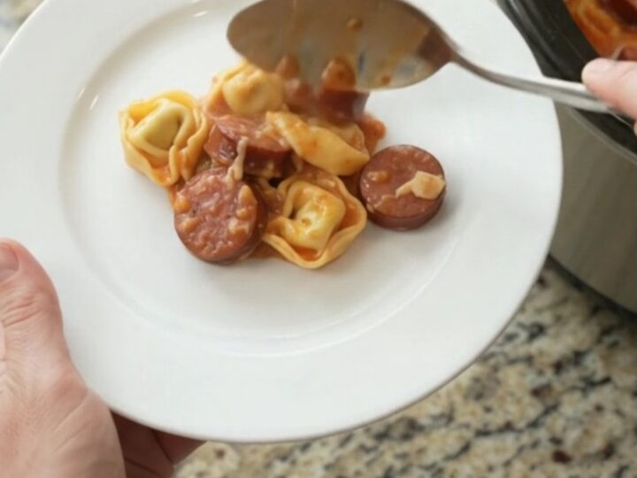 Slow cooker kielbasa tortellini marinara with melted cheese and golden crust
