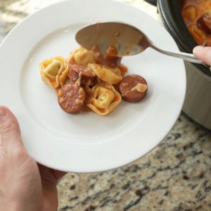 Slow cooker kielbasa tortellini marinara with melted cheese and golden crust