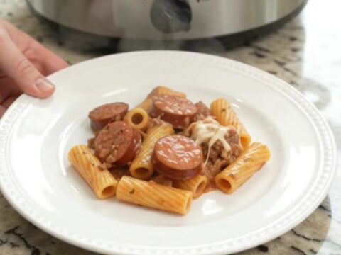 Creamy slow-cooker rigatoni with kielbasa, Boursin, and fontina in a black crock