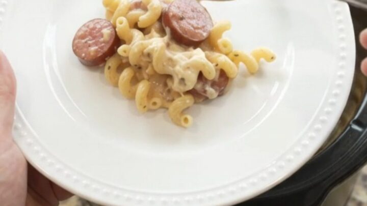Slow cooker full of creamy cavatappi pasta with kielbasa and melted provolone