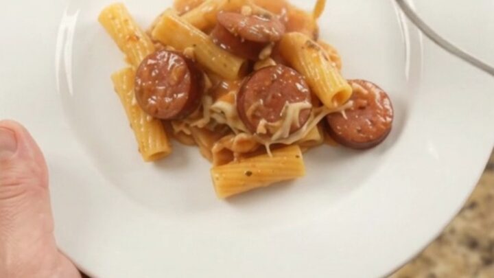 Slow cooker full of bubbling Boursin kielbasa ziti with melted cheese