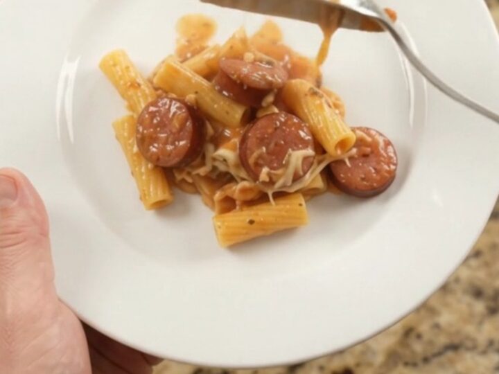 Slow cooker full of bubbling Boursin kielbasa ziti with melted cheese