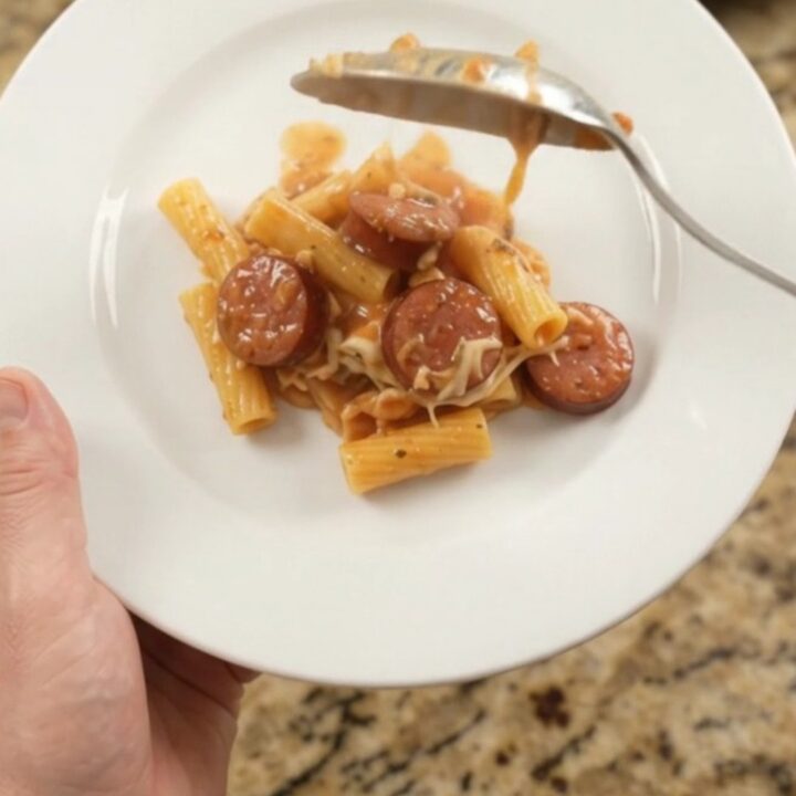Slow cooker full of bubbling Boursin kielbasa ziti with melted cheese