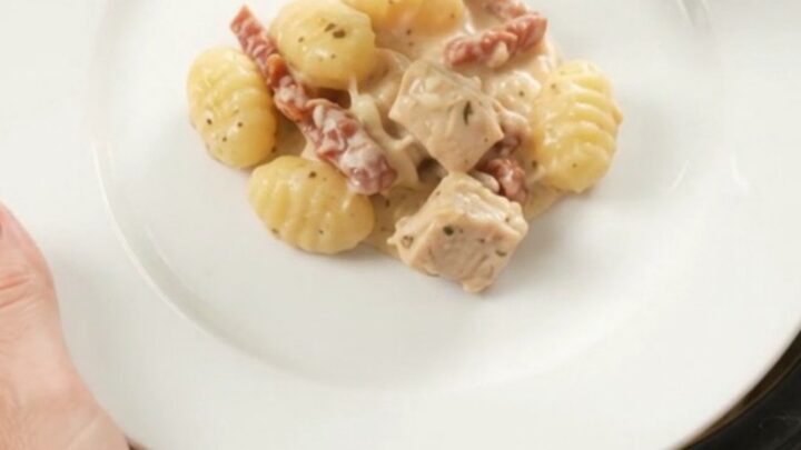Creamy Crockpot chicken Tuscan gnocchi with melted mozzarella in a slow cooker