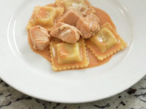 Slow cooker filled with creamy chicken vodka ravioli topped with melted mozzarella.
