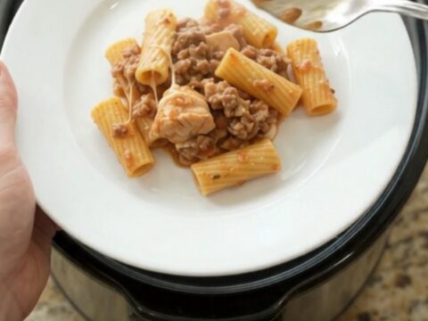 Slow cooker chicken rigatoni with melted provolone and ricotta in a black crockpot