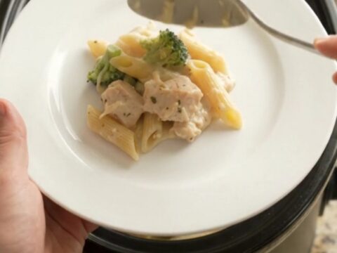 Crockpot Chicken Alfredo Penne with melted cheese and tender pasta, served in a bowl
