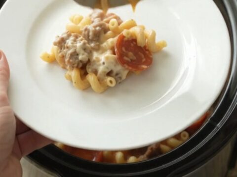 Creamy cavatappi with pepperoni and sausage in a slow cooker, topped with melted mozzarella.