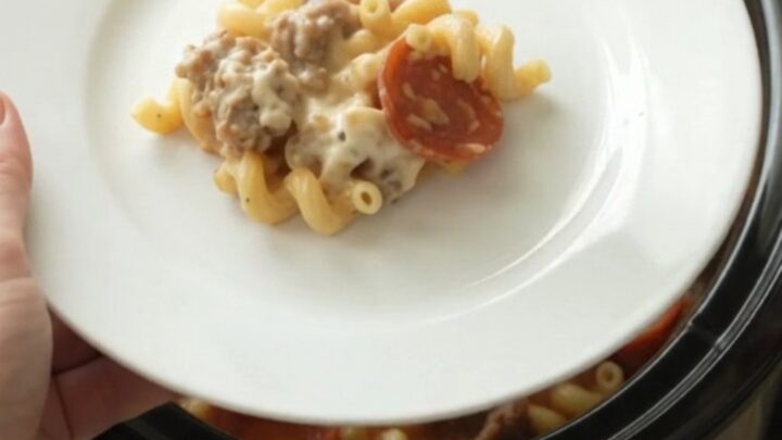 Creamy cavatappi with pepperoni and sausage in a slow cooker, topped with melted mozzarella.
