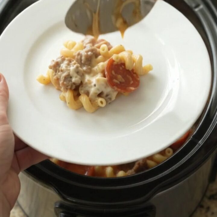Creamy cavatappi with pepperoni and sausage in a slow cooker, topped with melted mozzarella.