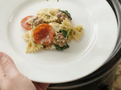 Crockpot Boursin pepperoni pesto farfalle with melted cheese and sausage