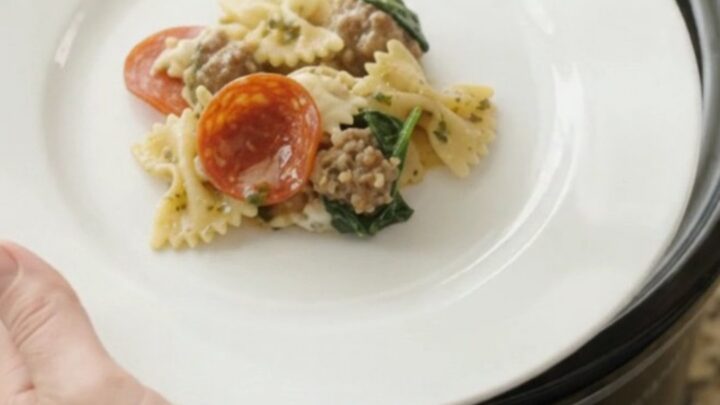 Crockpot Boursin pepperoni pesto farfalle with melted cheese and sausage