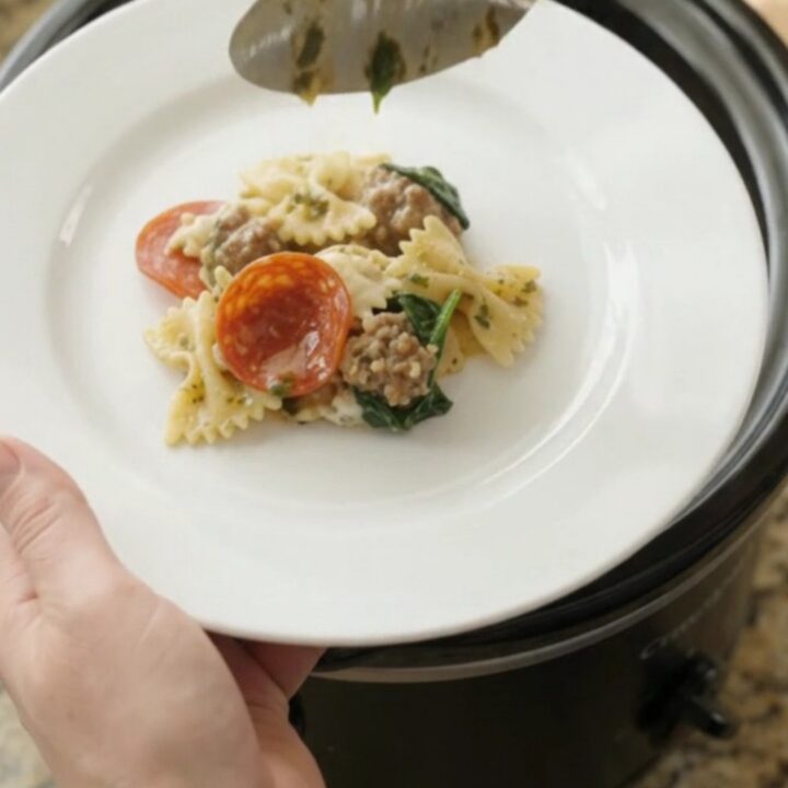 Crockpot Boursin pepperoni pesto farfalle with melted cheese and sausage
