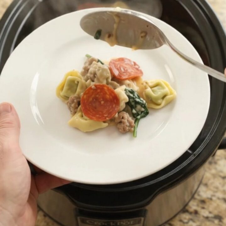 Crockpot pasta bake with pepperoni, sausage, tortellini, and melted provolone