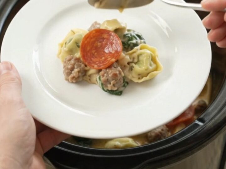 Crockpot Boursin pepperoni sausage tortellini with melted cheese and steam rising