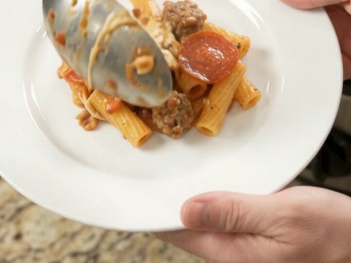Slow cooker bubbling with cheesy pepperoni sausage ziti
