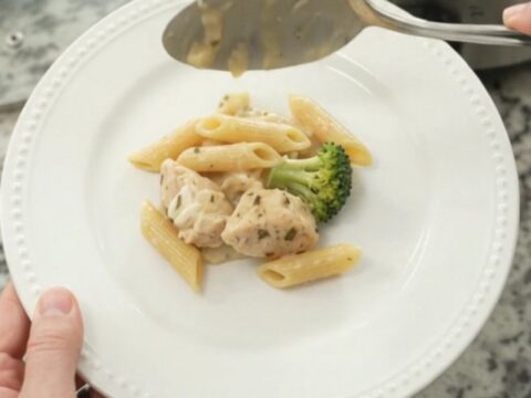 Bubbling Crockpot chicken Alfredo penne with broccoli and melted cheese