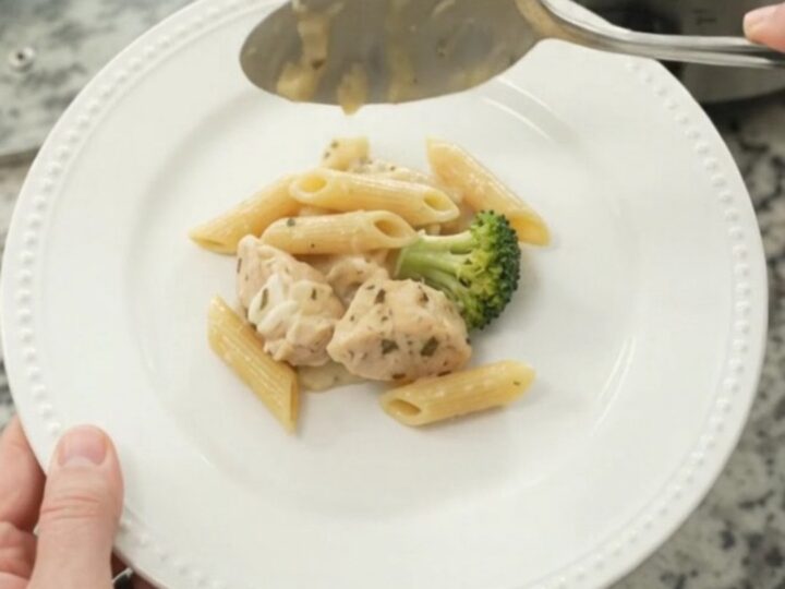 Bubbling Crockpot chicken Alfredo penne with broccoli and melted cheese