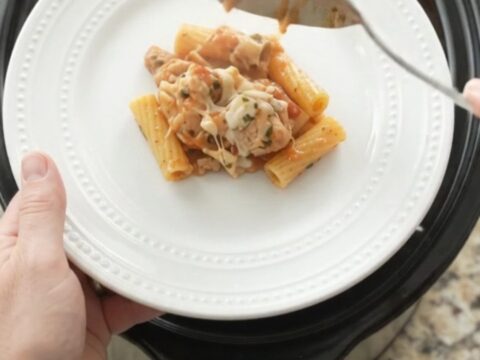 Bubbling slow cooker chicken baked ziti with melted mozzarella and creamy sauce