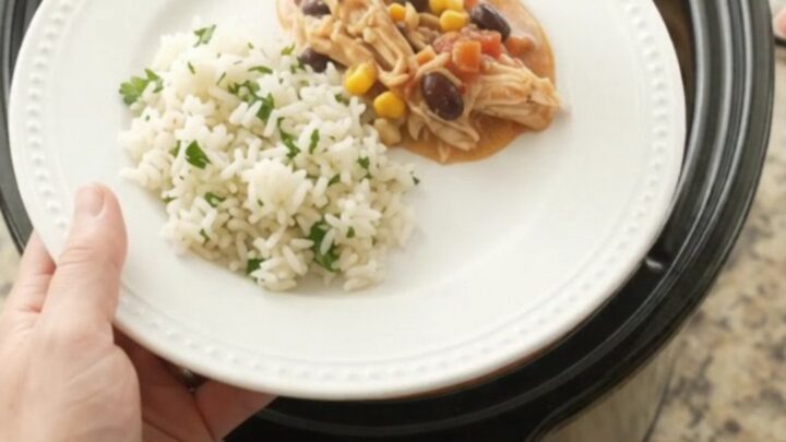 Shredded fiesta chicken in creamy cheese sauce with black beans and corn in a slow cooker