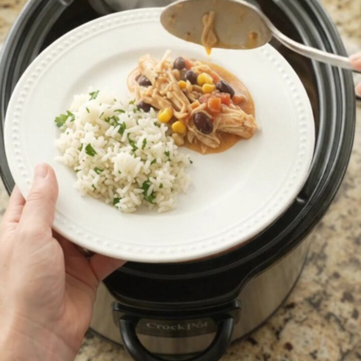 Shredded fiesta chicken in creamy cheese sauce with black beans and corn in a slow cooker